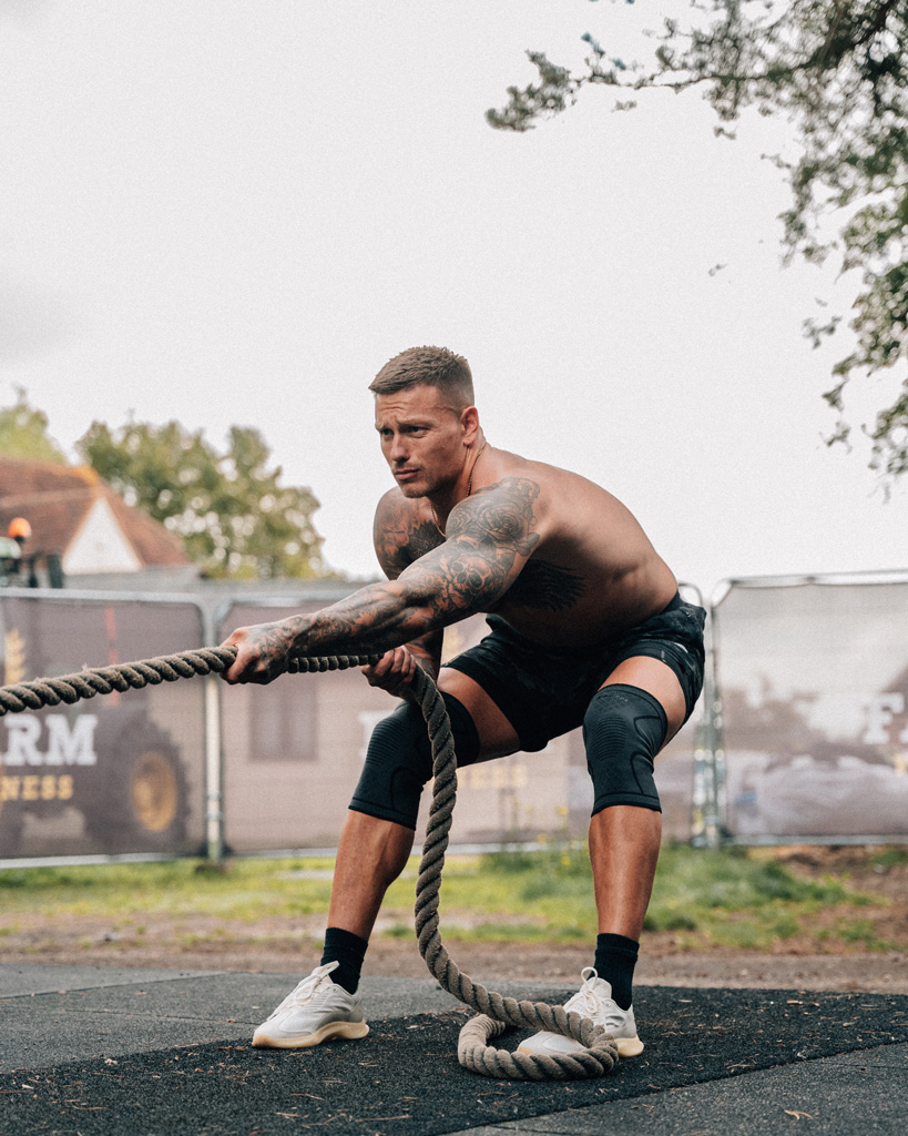 Coach is working out with heavy rope.